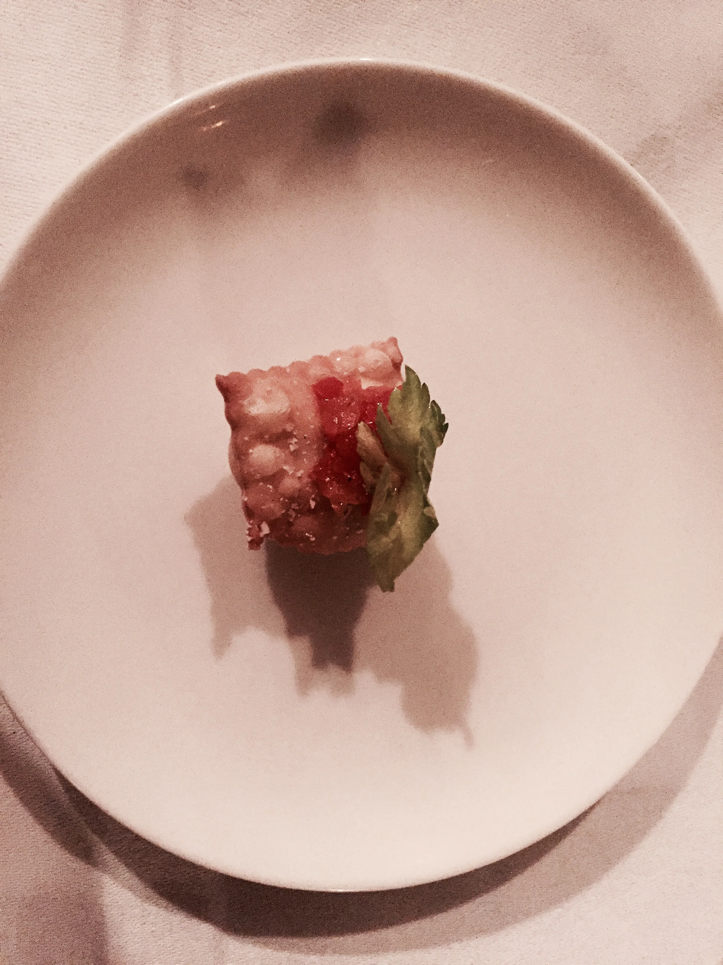 An amuse bouche of puff pastry and fresh vegetables