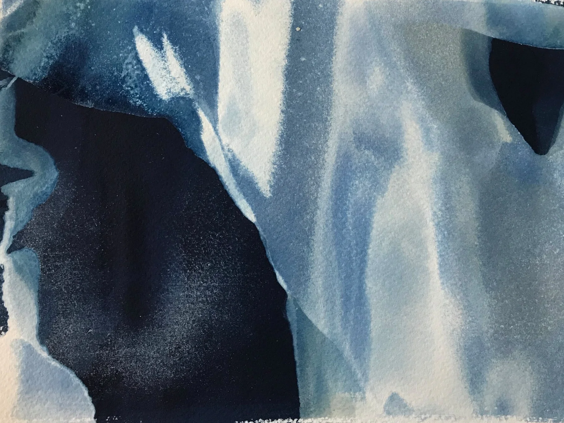 Sand and water rush over paper to create unique cyanotype