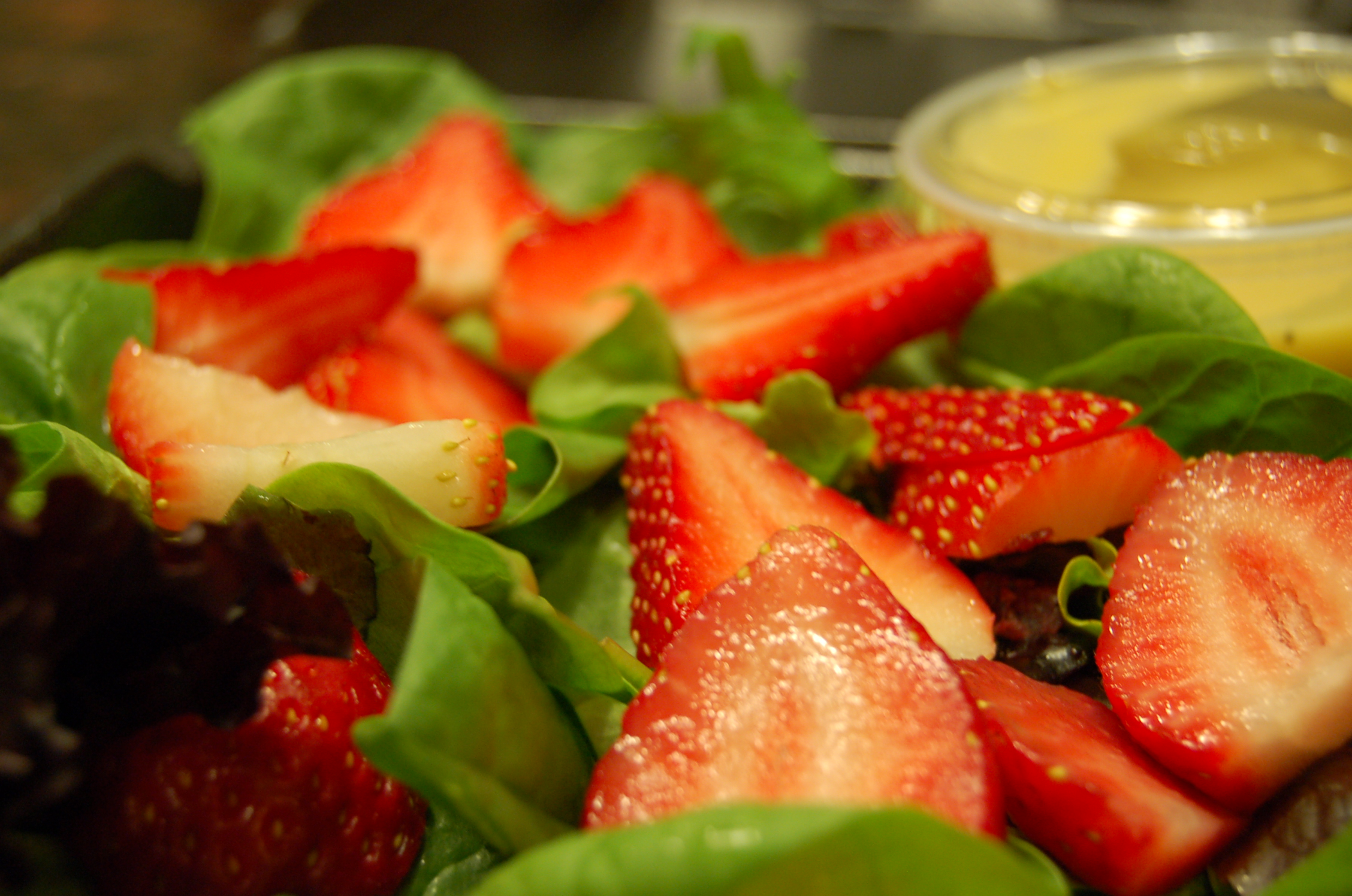 Wild Field Green Leaf Salad Topped with Fresh Strawberries
