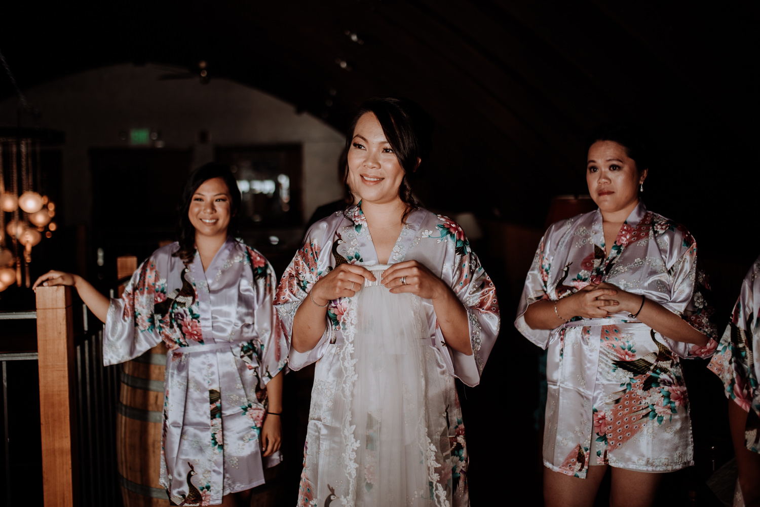 maid of honor holds veil and waits to put on brides veil