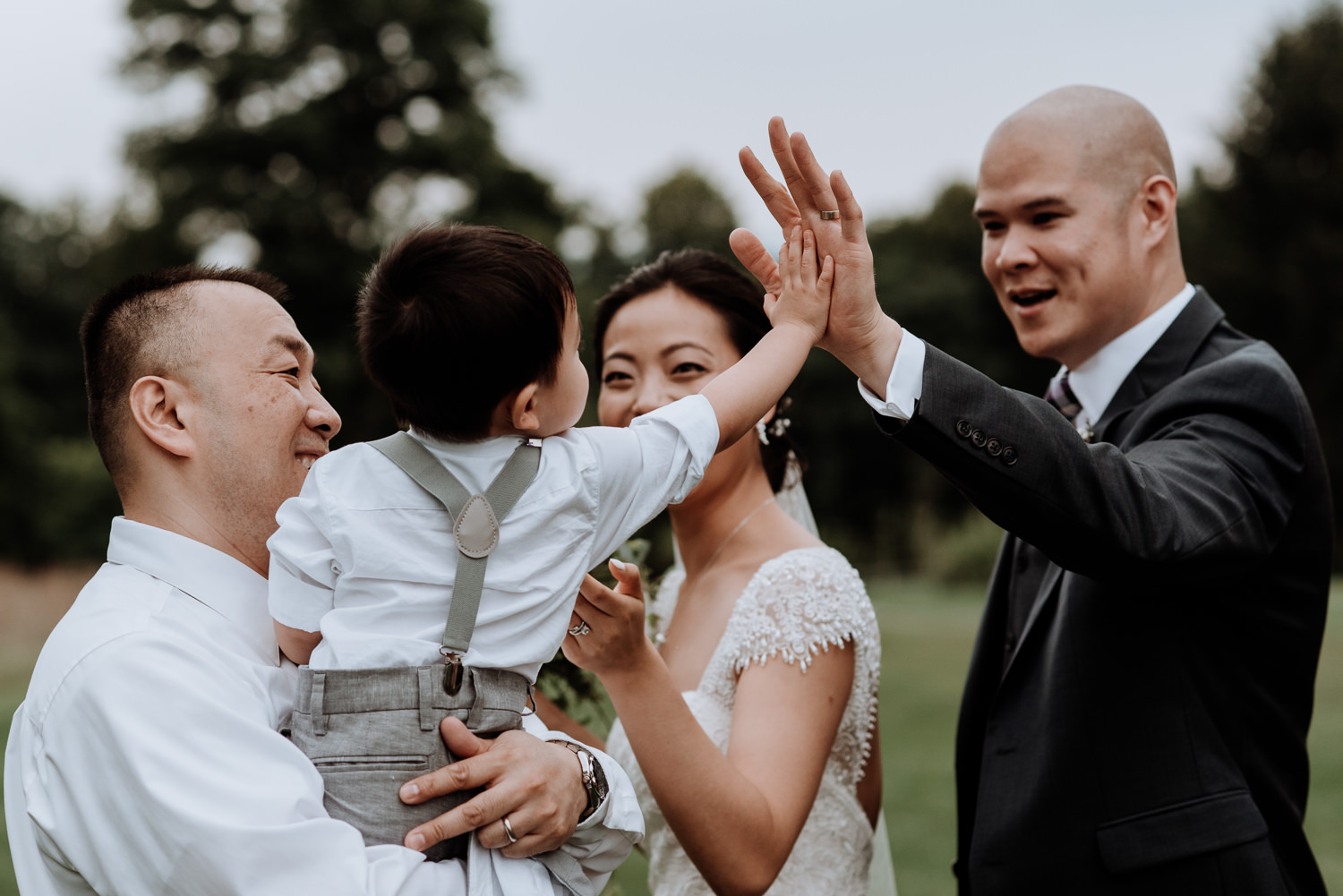 ring bearer gives high five to groom