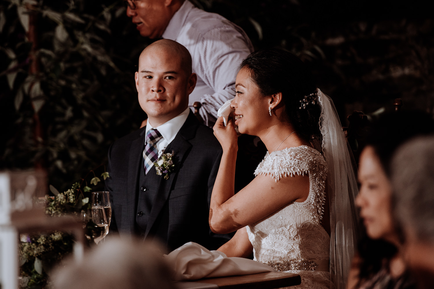 bride wipes tears during toast