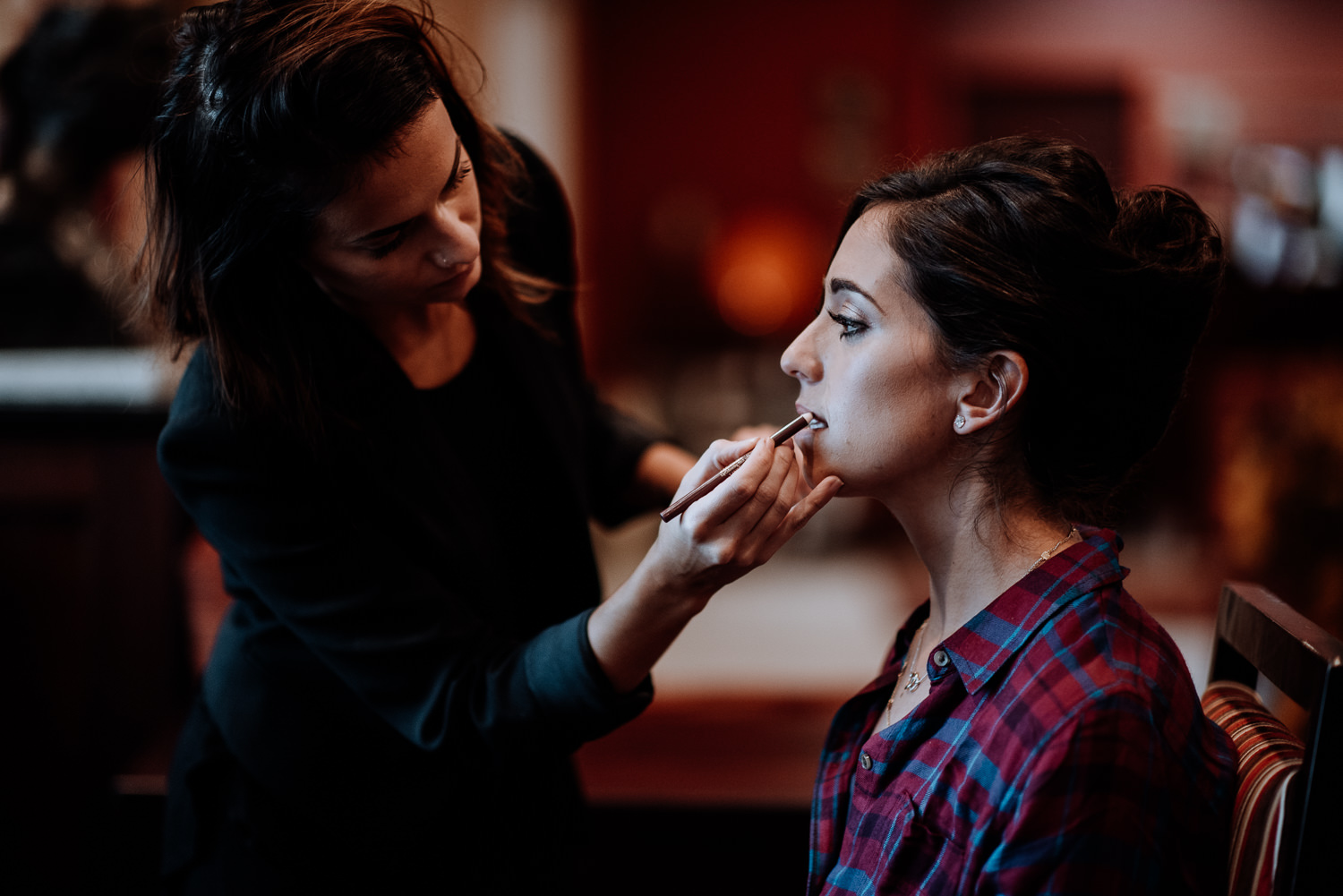 Bride gets her makeup professionally done before her wedding at Red Maple Vineyard
