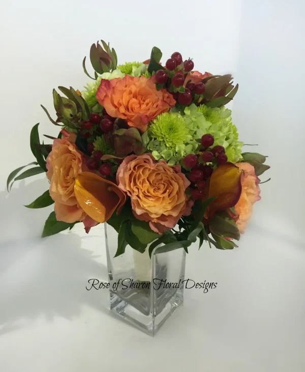 Orange and Green Hand-Tied Bouquet with Free Spirit Roses, Hypericum Berries, Green Button Mums, and Leucadendron. Rose of Sharon Floral Designs