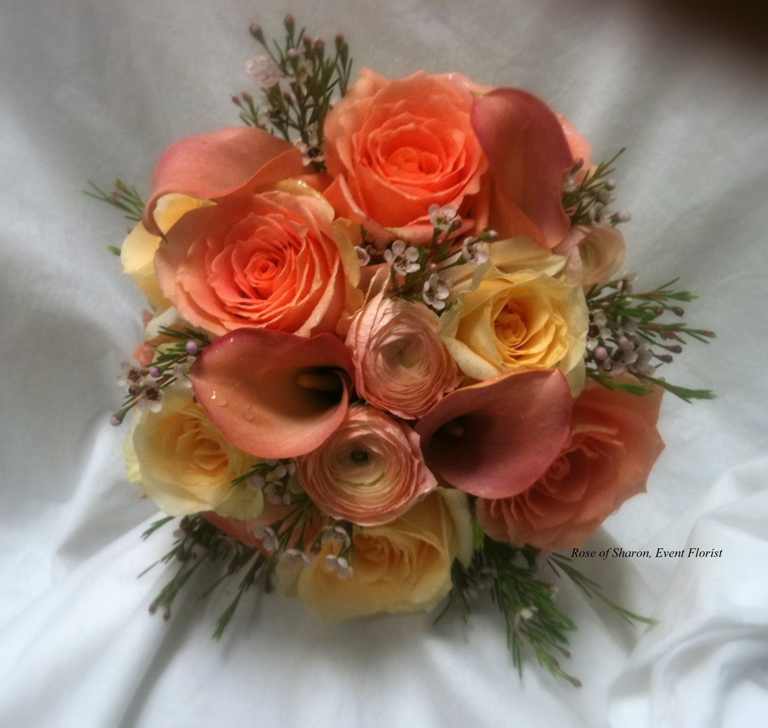 Hand-Tied Round Bouquet. Orange Roses, Calla Lilies, and Ranunculus. Rose of Sharon Floral Designs