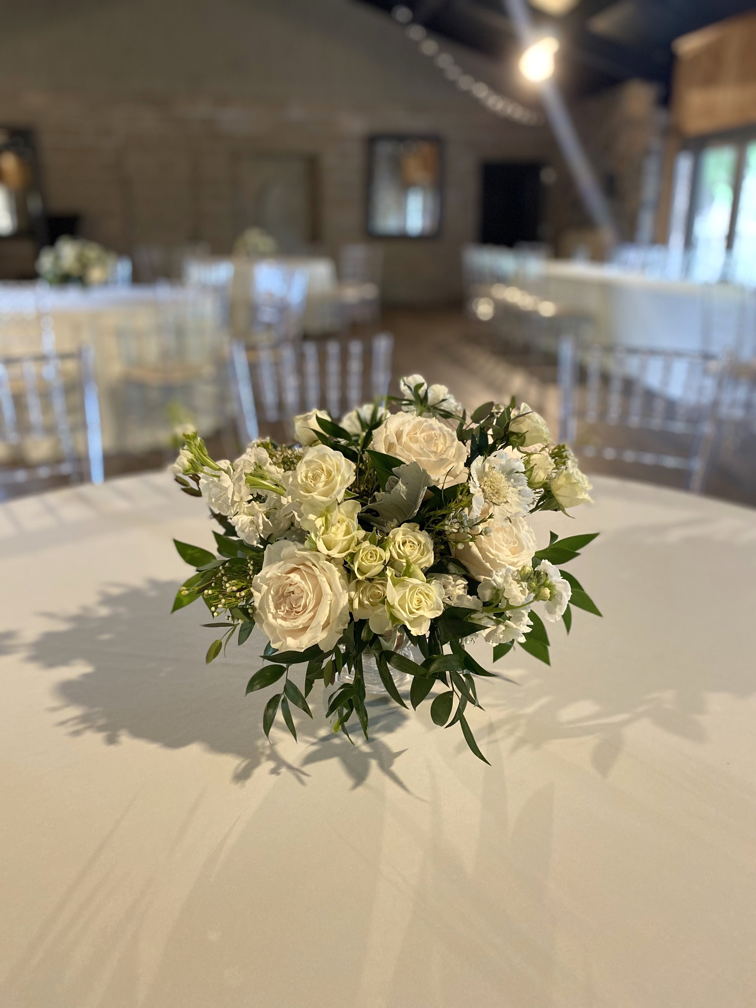 Stone Chapel at MattLane Farm Weddings. Wedding flowers by Rose of Sharon Floral Design Studio. Lush centerpiece with stock and Italian ruscus.