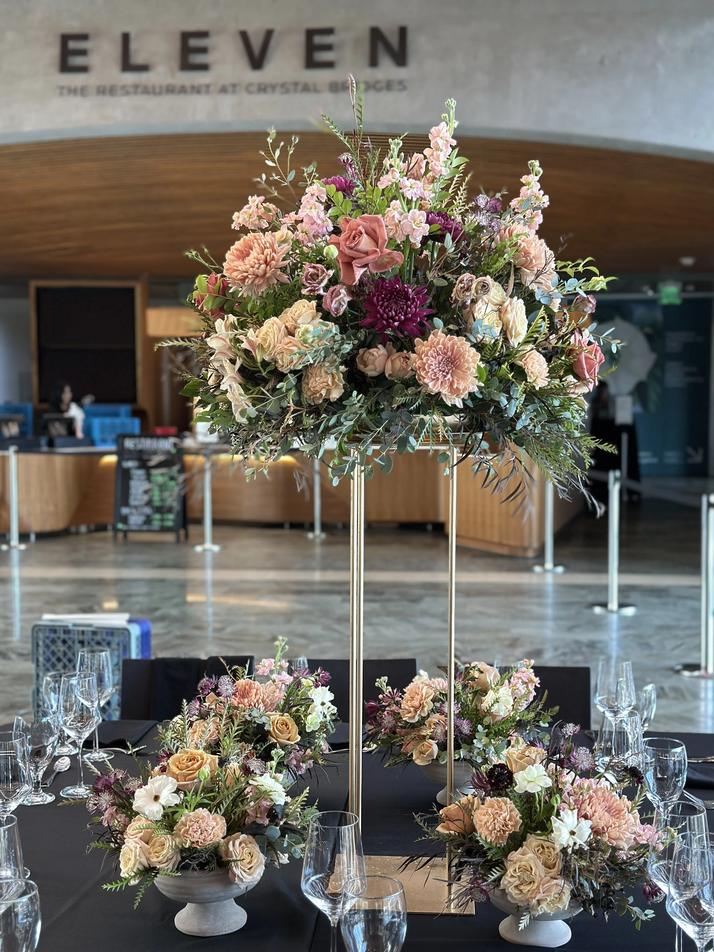 rose of sharon floral design studio corporate event flowers crystal bridges university of arkansas conference arrangements and centerpieces with peach and plum flowers harlow stand eleven restaurant