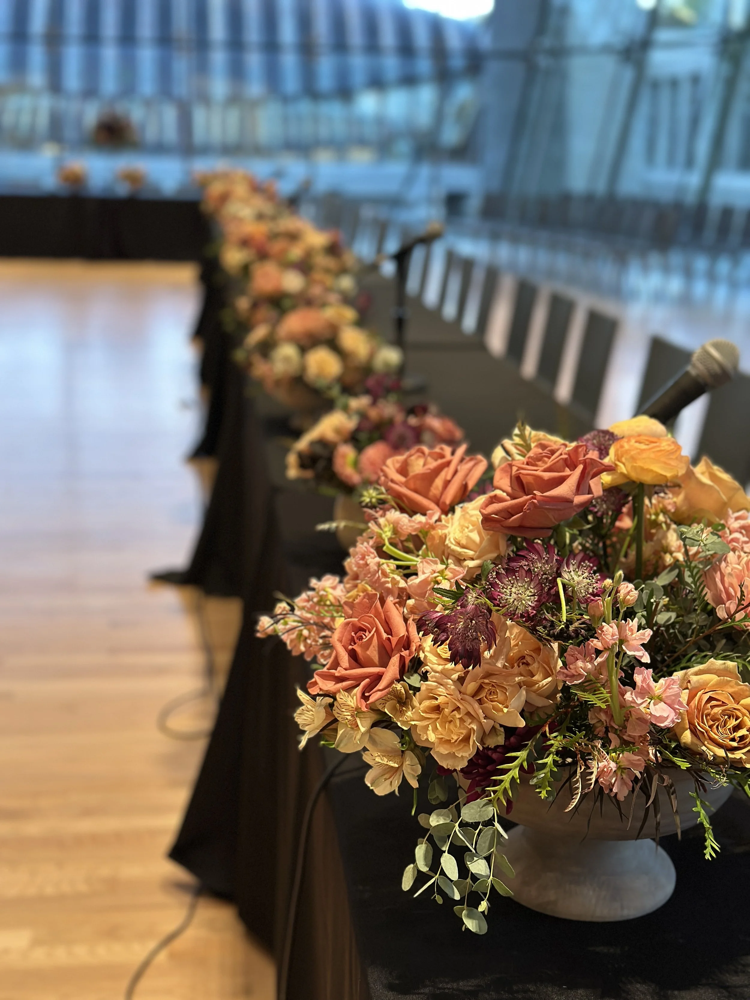 rose of sharon floral design studio corporate event flowers crystal bridges university of arkansas conference arrangements and centerpieces with peach and plum flowers compote lush full design