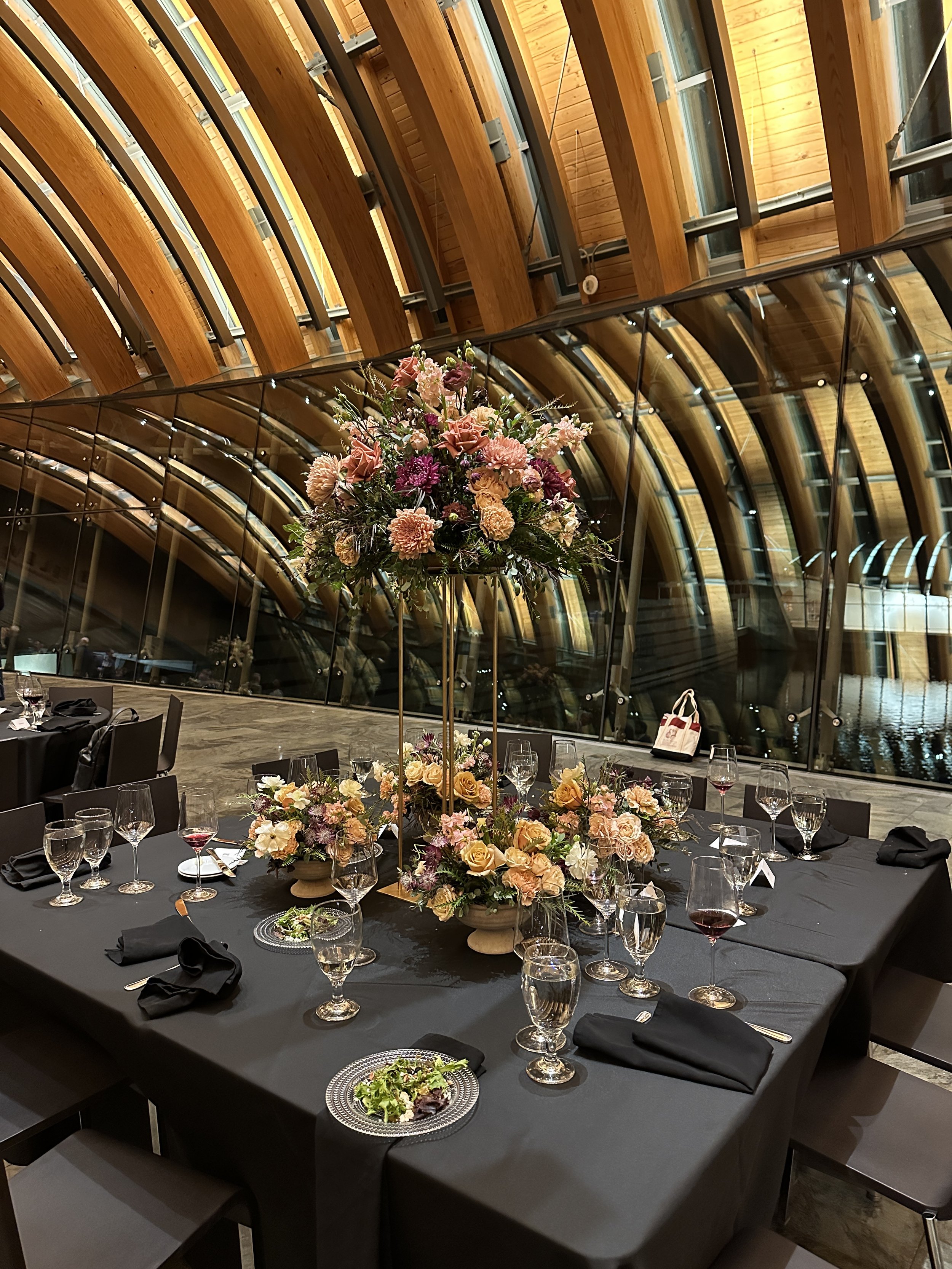 rose of sharon floral design studio corporate event flowers crystal bridges university of arkansas conference arrangements and centerpieces with peach and plum flowers harlow stands eleven restaurant