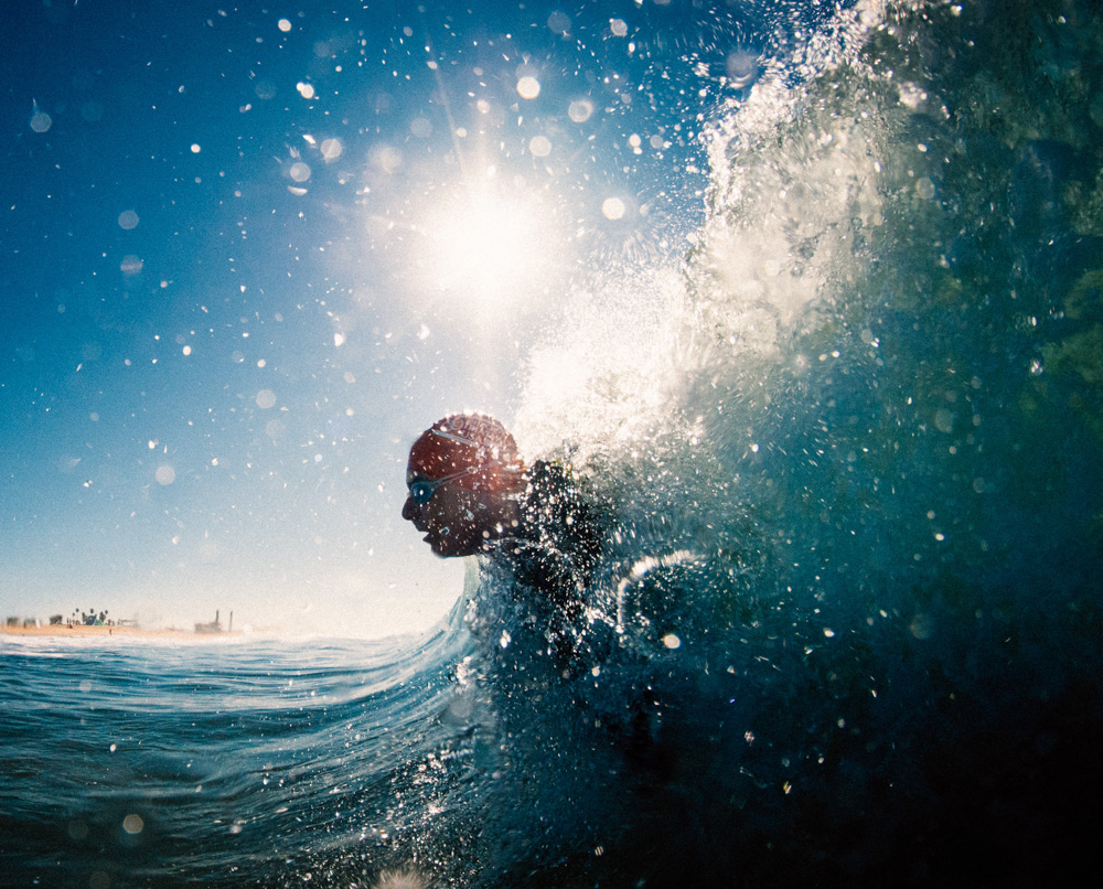 Triathlete inside wave during triathlon