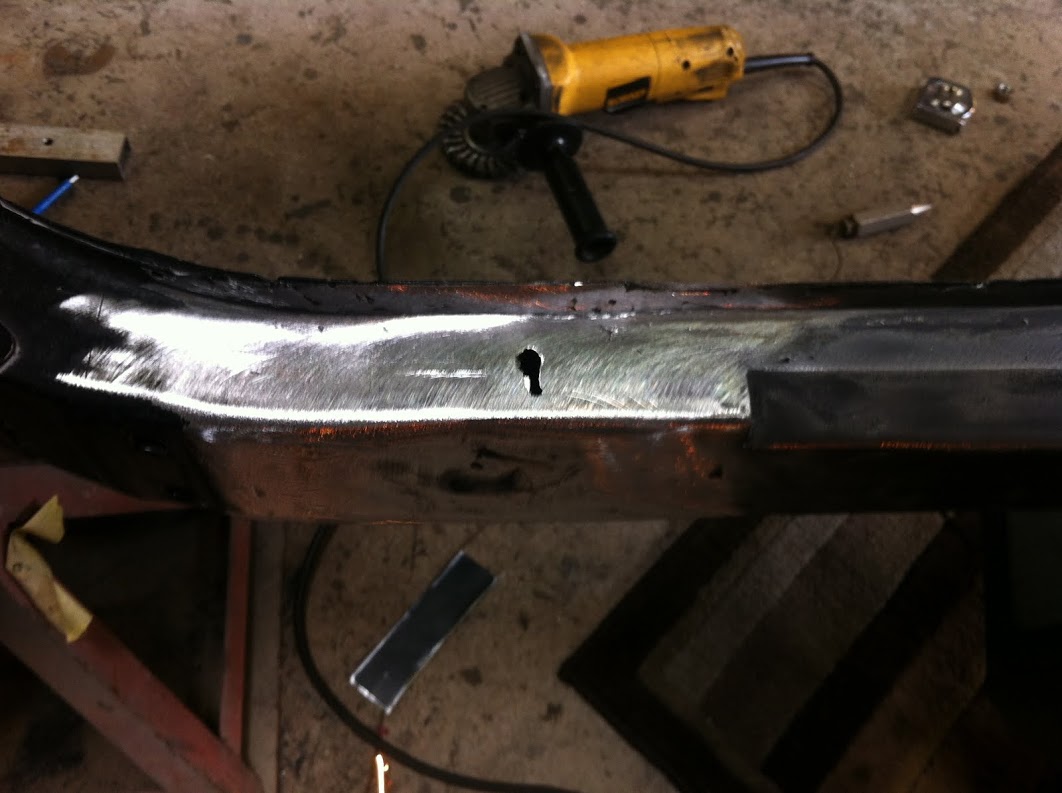The frame was a little rusty, the hole in the picture was opened up with a pocket knife.