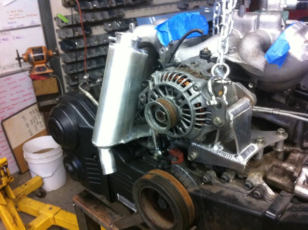 Alternator mount doubles as engine hanger