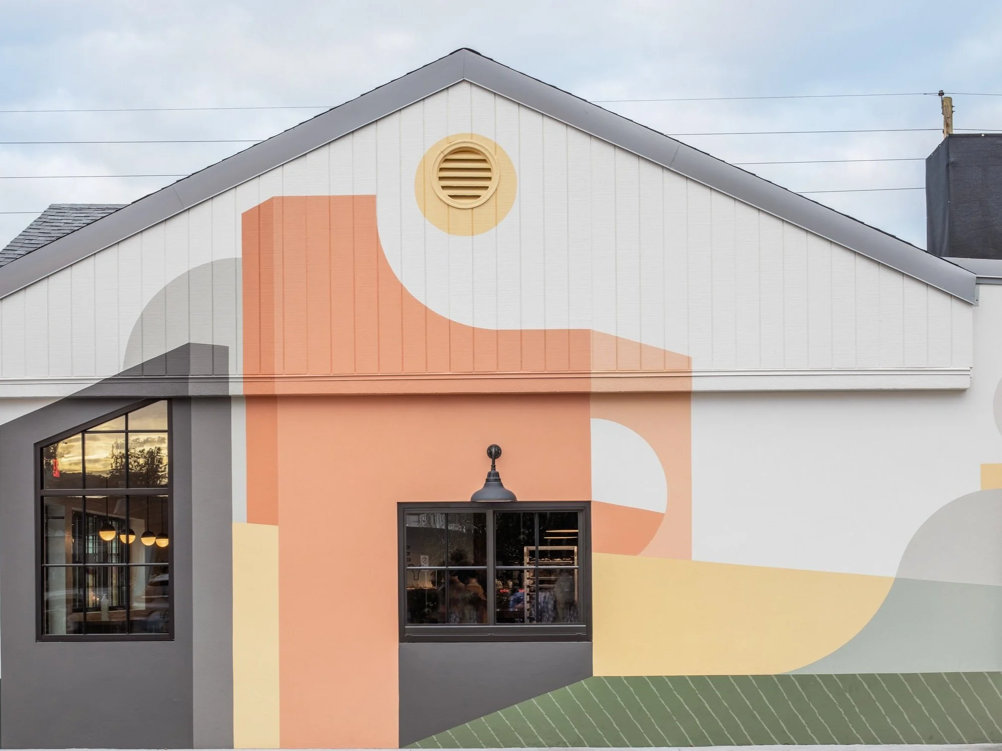 Geometric, architectural color blocks form this hand-painted exterior mural in Orlando Florida.