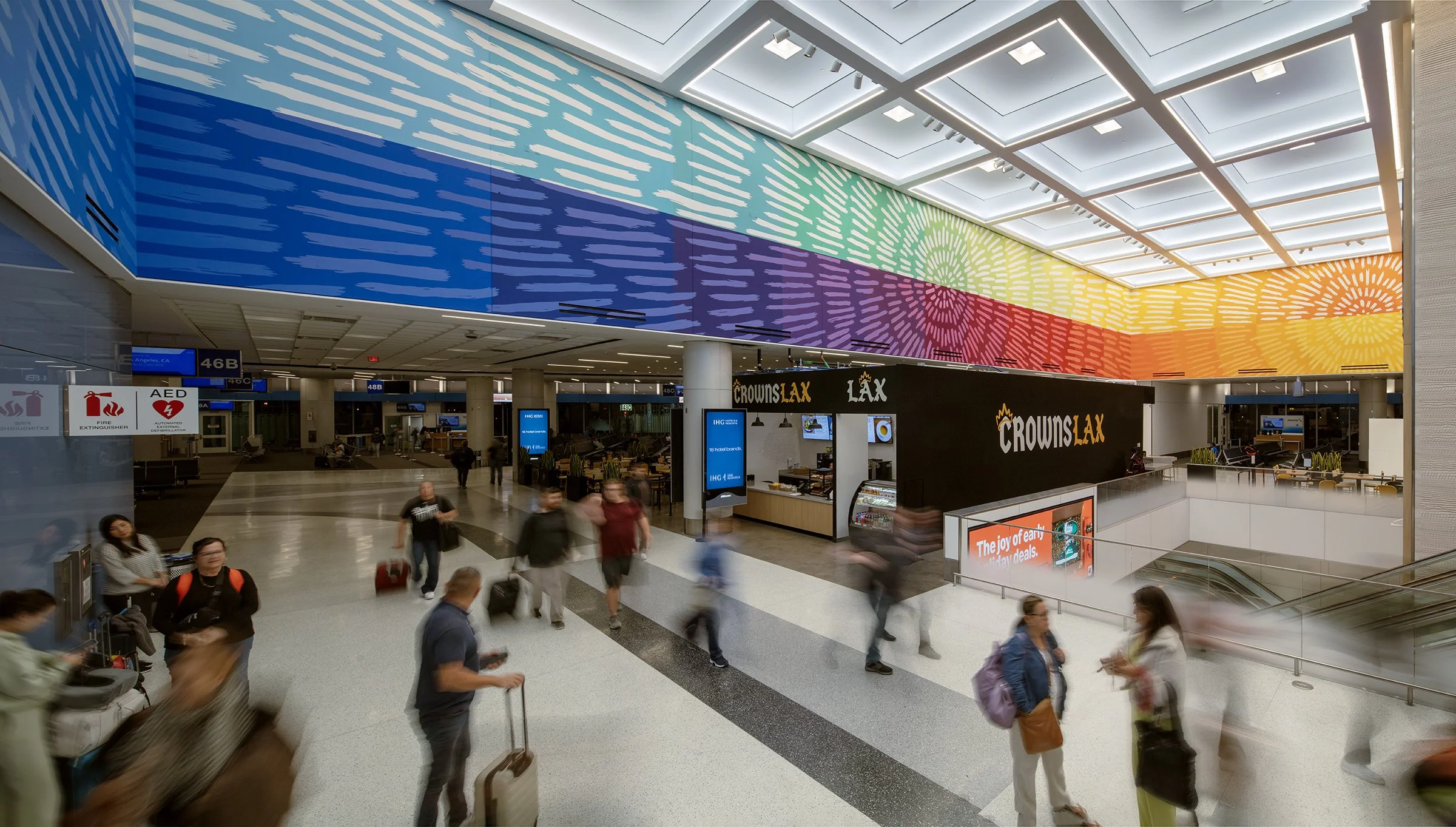 A massive 60-color mural by Allison Kunath stretches overhead in Terminal 4 at Los Angeles Airport.