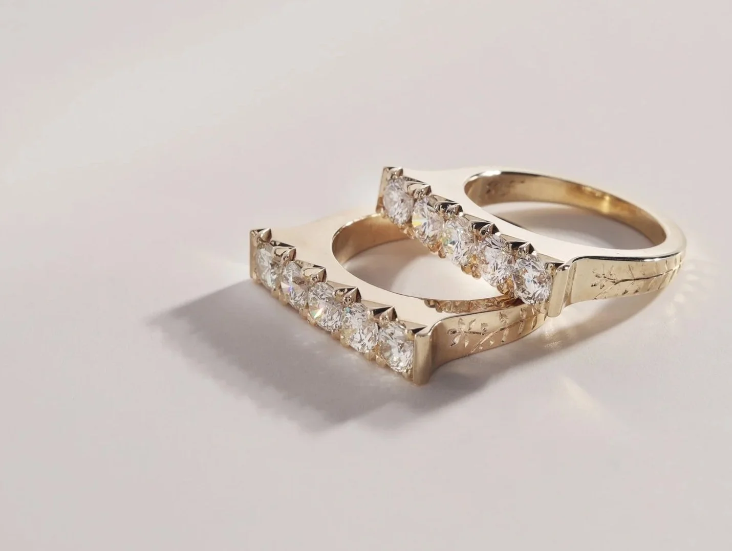 Custom made, matching white diamond rings with hand engraving.