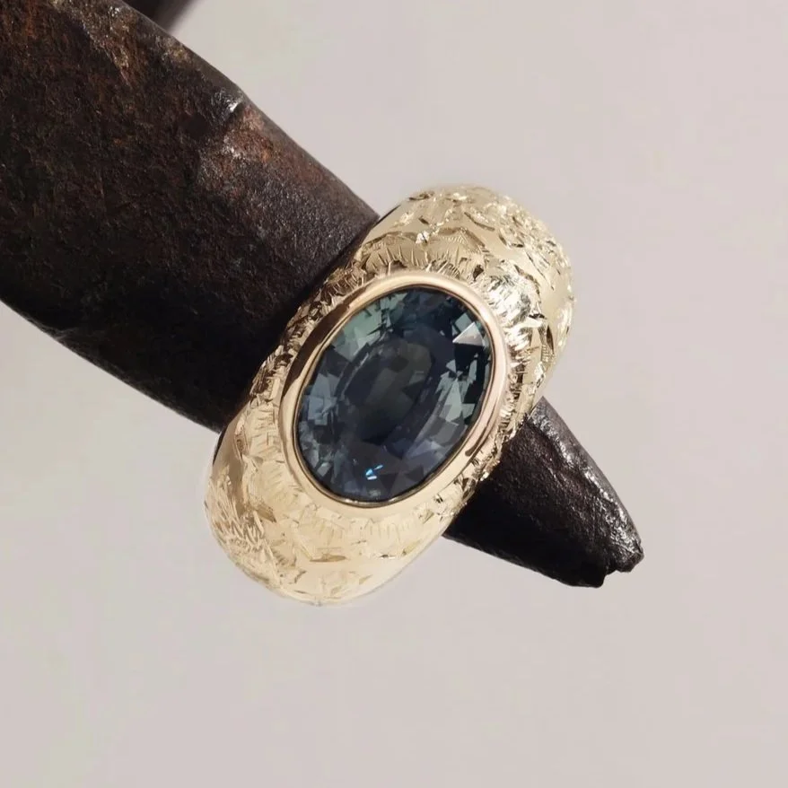 3ct teal sapphire in hand engraved 18k gold
