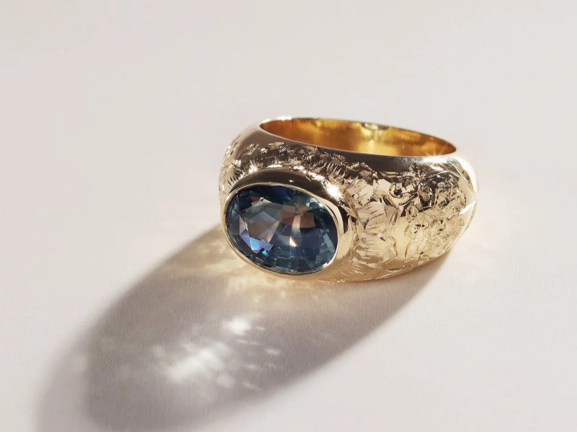 3ct teal sapphire in hand engraved 18k gold
