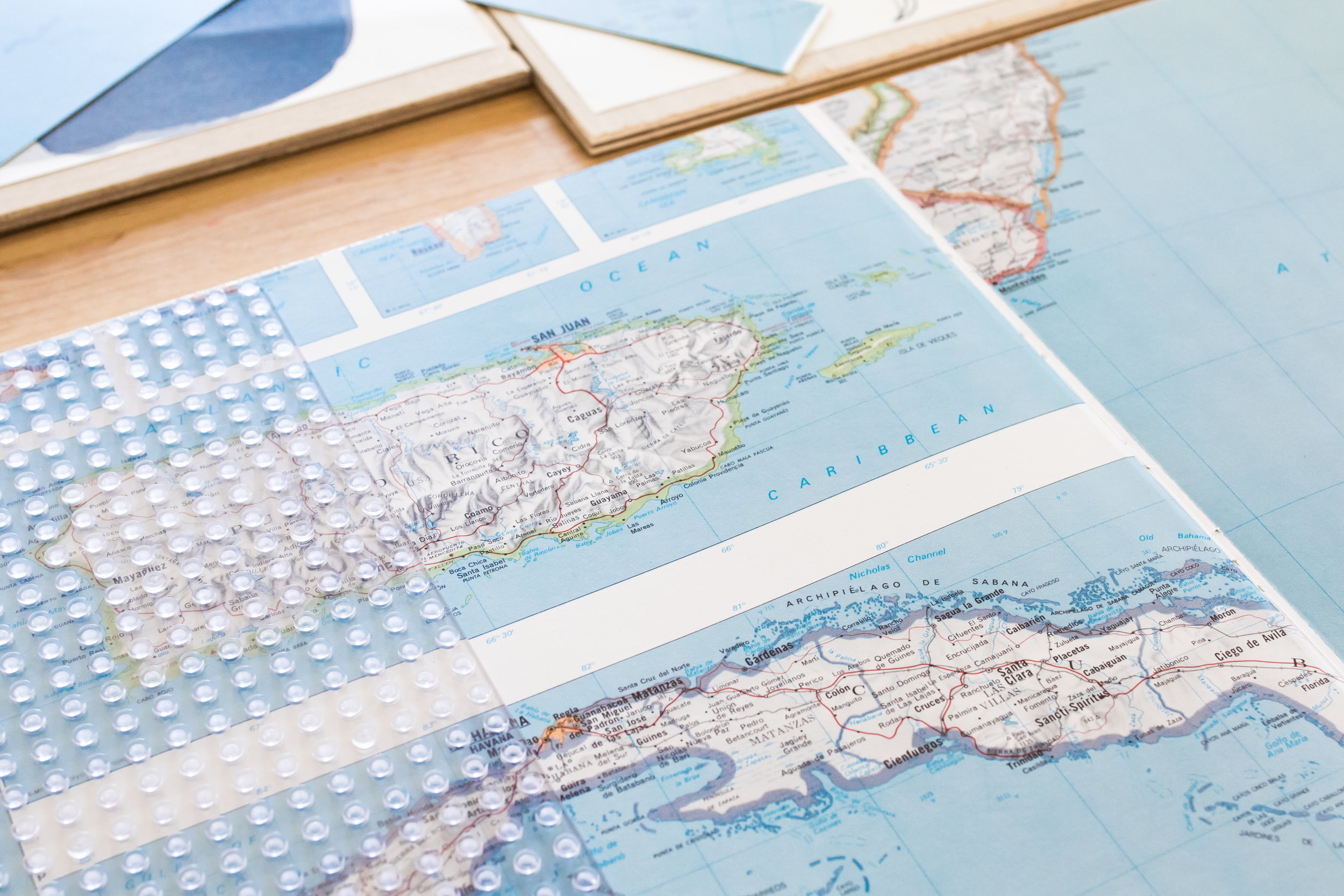 The map pages were used on the shelves and as a border on the panels on the walls. 