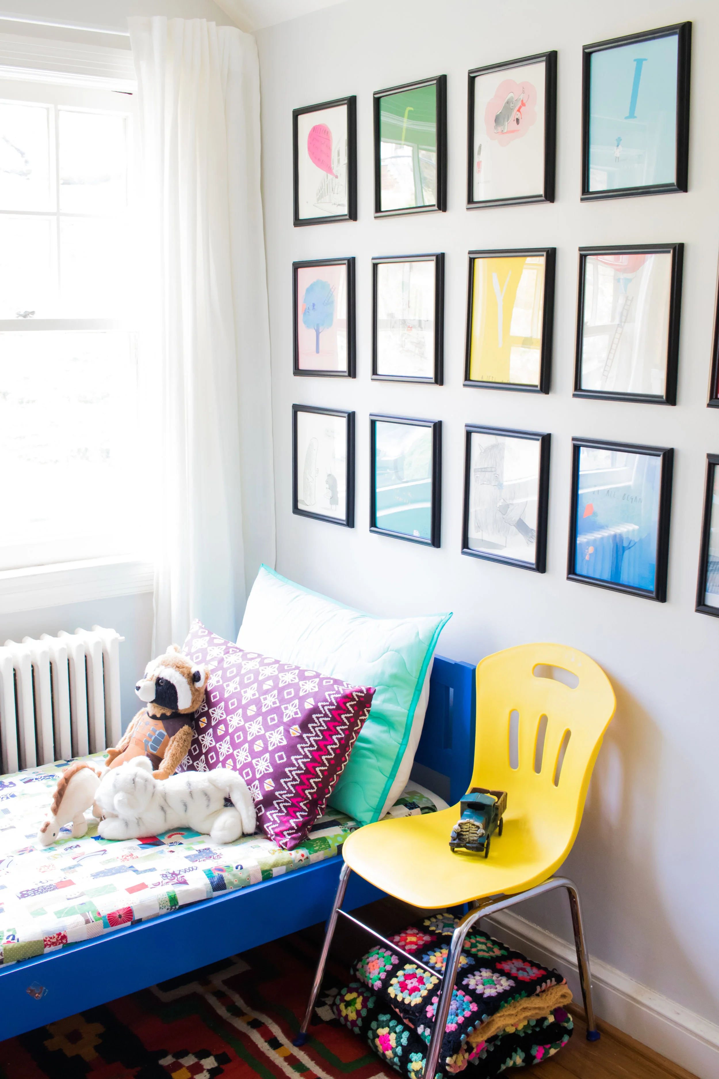 The blue bed is from IKEA, the pillows are from Target and IKEA. I made the quilt, and you can see more about that here . The grid of images are pages from Oliver Jeffers' alphabet book. 