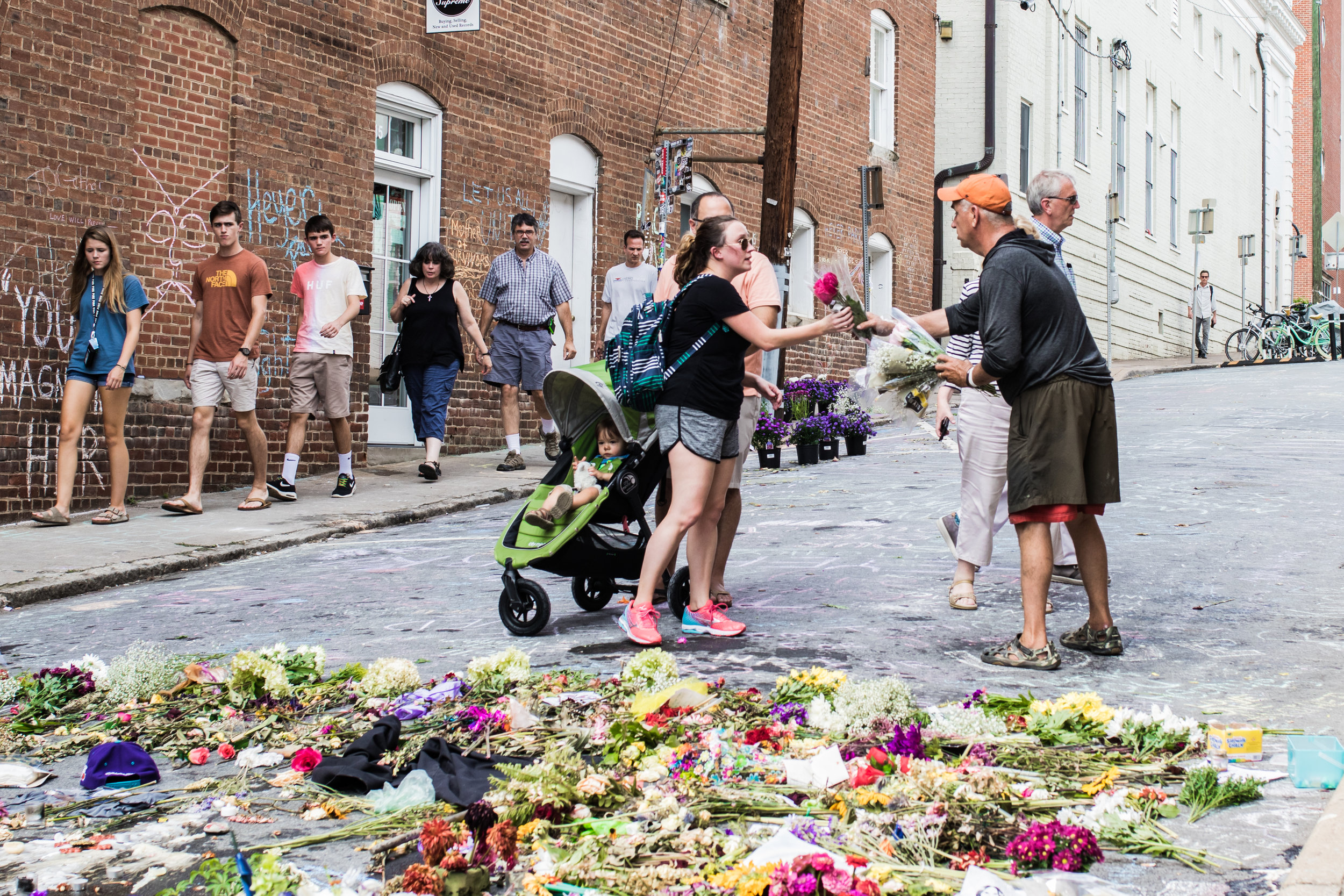 This man had brought a truck full of flowers. He asked everyone around if they wanted to lay them down. He didn't charge anything for them - he just wanted to bring us together in remembering Heather Heyer. 