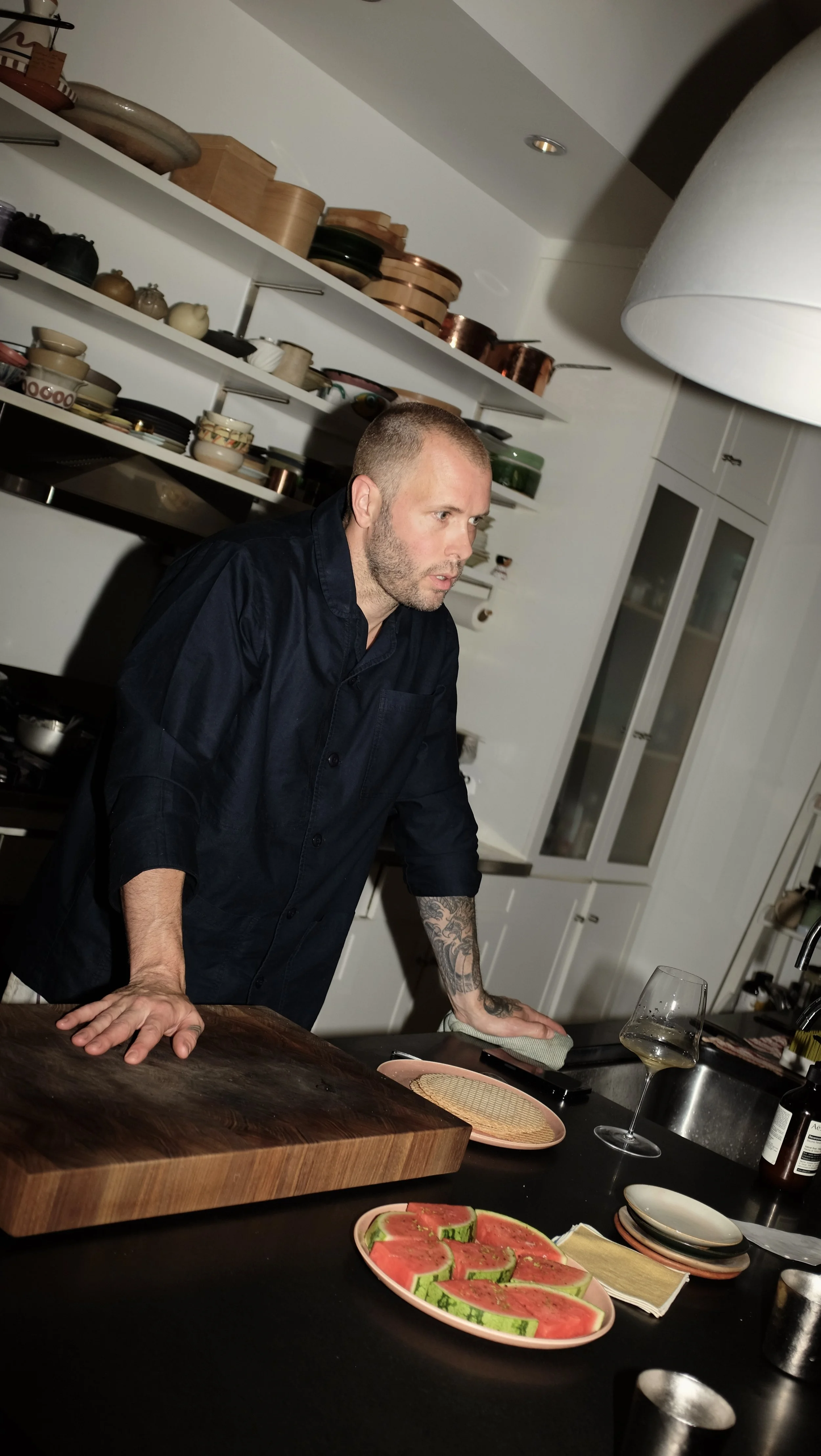 Mike Bagale wearing black chef coat designed by Finery.
