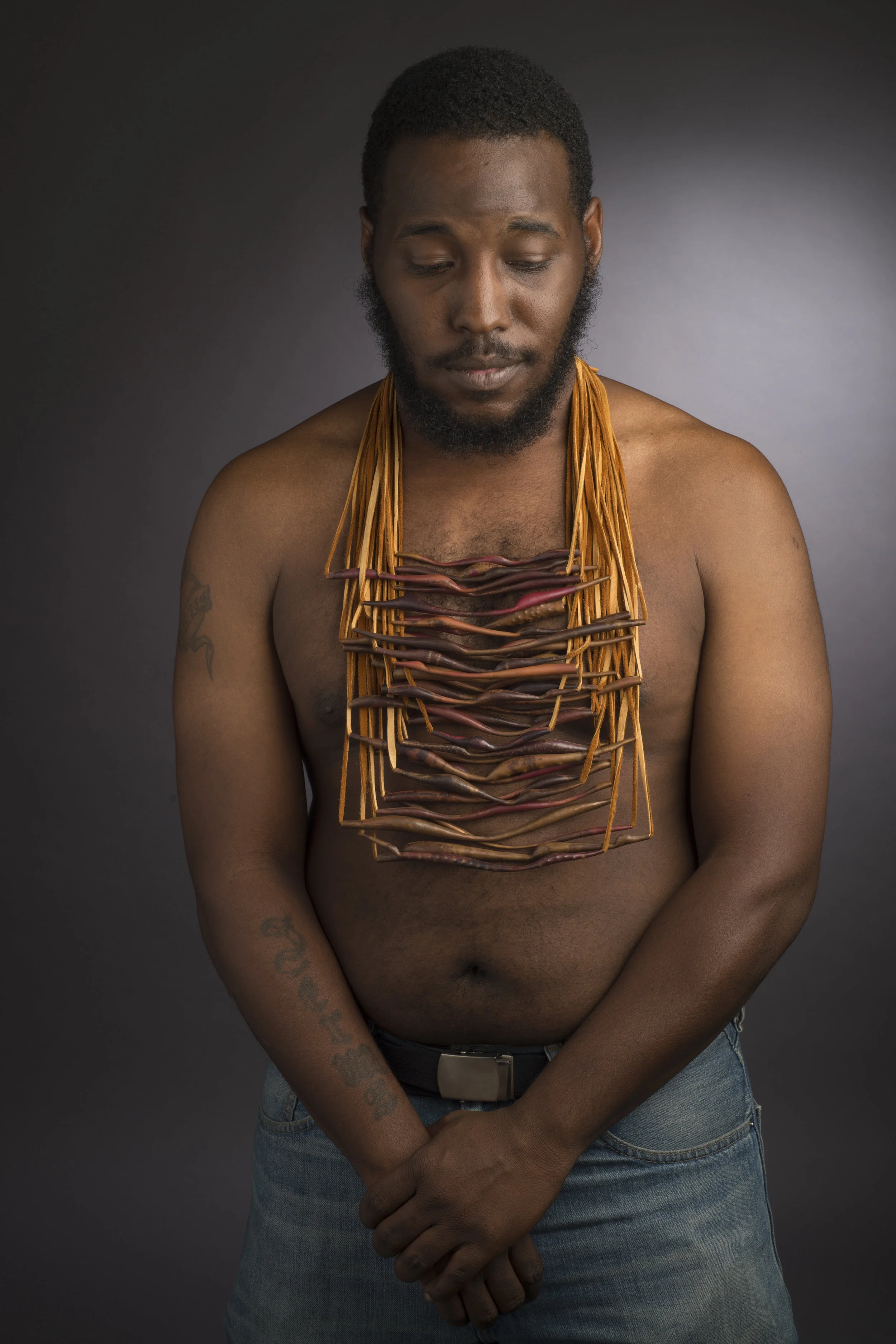 This neckpiece is comprised of 38 individual necklaces, each of which is a hand formed spiculum-like pendant, strung on buckskin. The forms of the individual copper beads were inspired by natural forms of mountains, legs, twigs, seed pods and more, as part of a body of work exploring recurring forms in nature and in human cultures. The overall form of the necklace was conceived of as a status symbol reflecting an accumulation of wealth as a means to gain respect, to be seen as beautiful, important, or powerful. The piece also reflects the human instinct to collect, a compulsion that created the art world as we know it. Buckskin, Copper 18”x9”x3” 2015