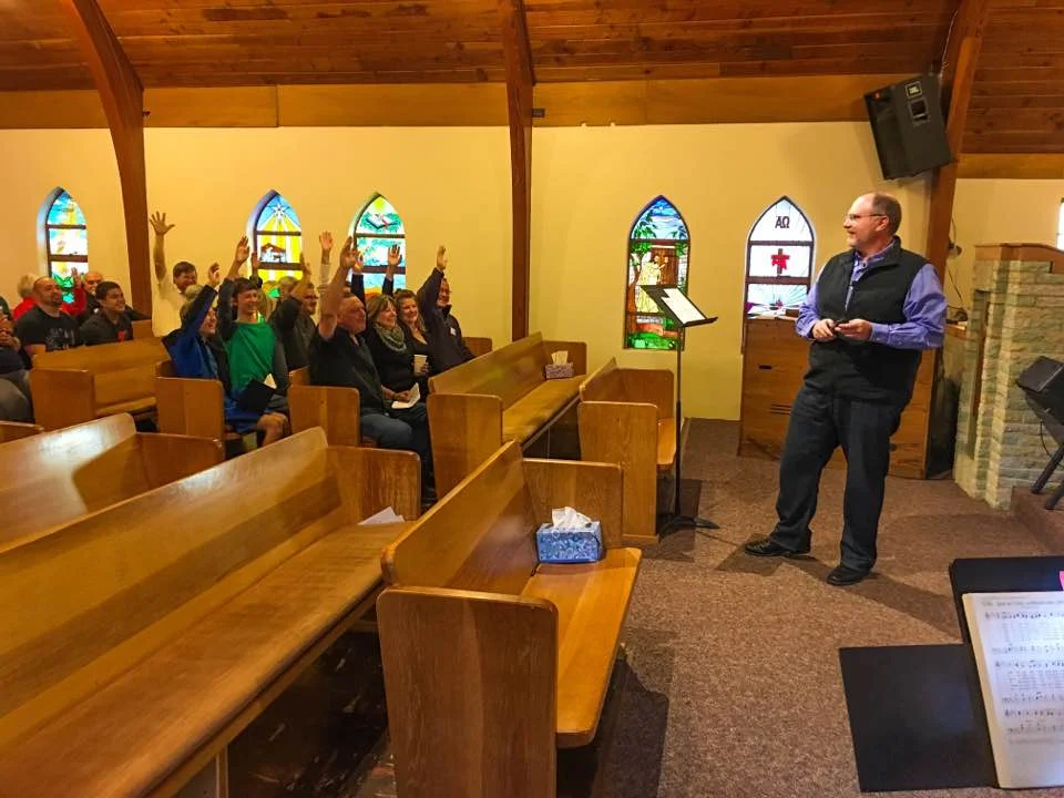 Pastor Mark had a stunned look on his face when every hand went up for Thanksgiving & Prayer. Something was up... That's when the flash mob stood and everyone began singing.