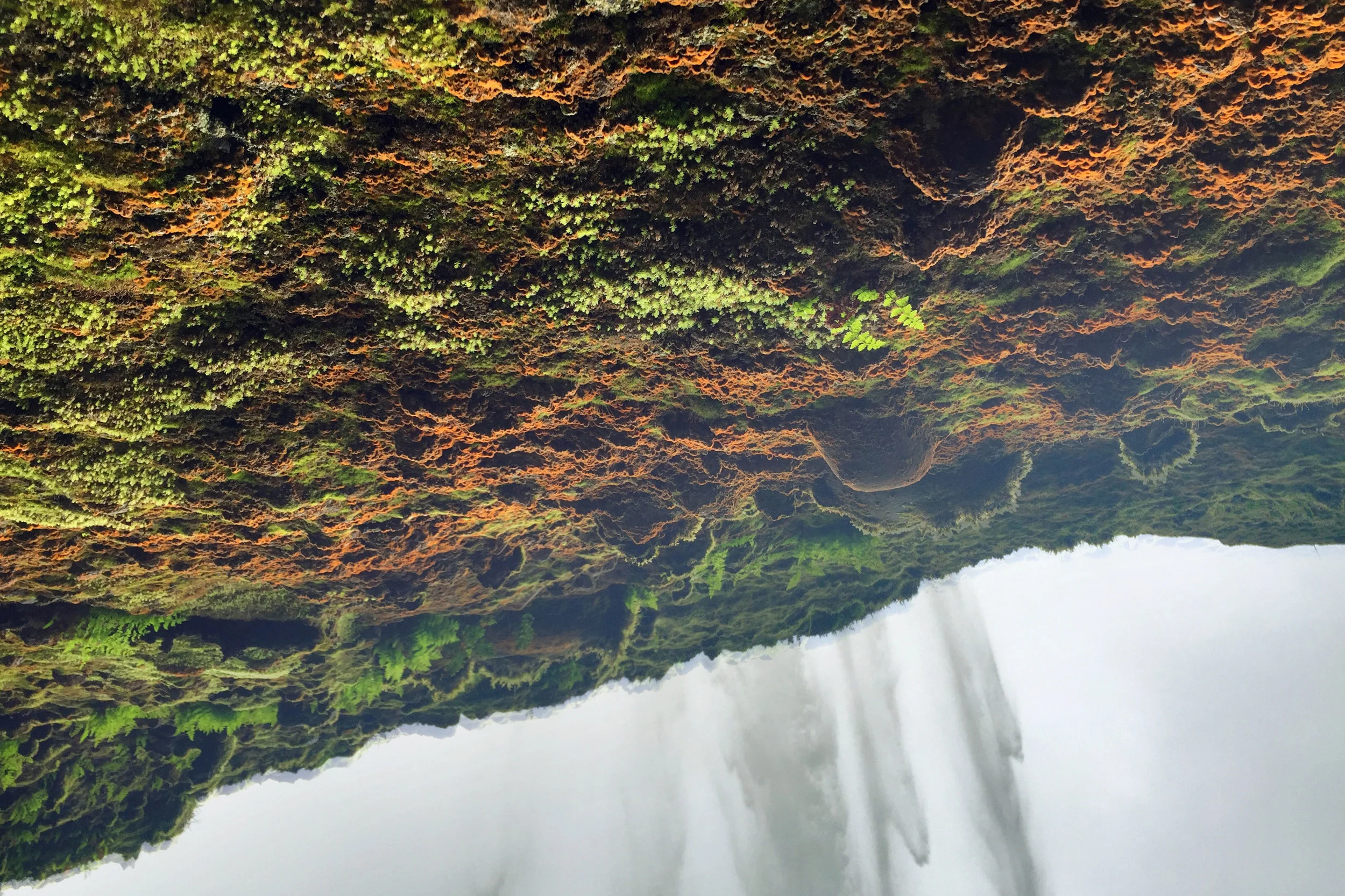 Under a waterfall looking up.