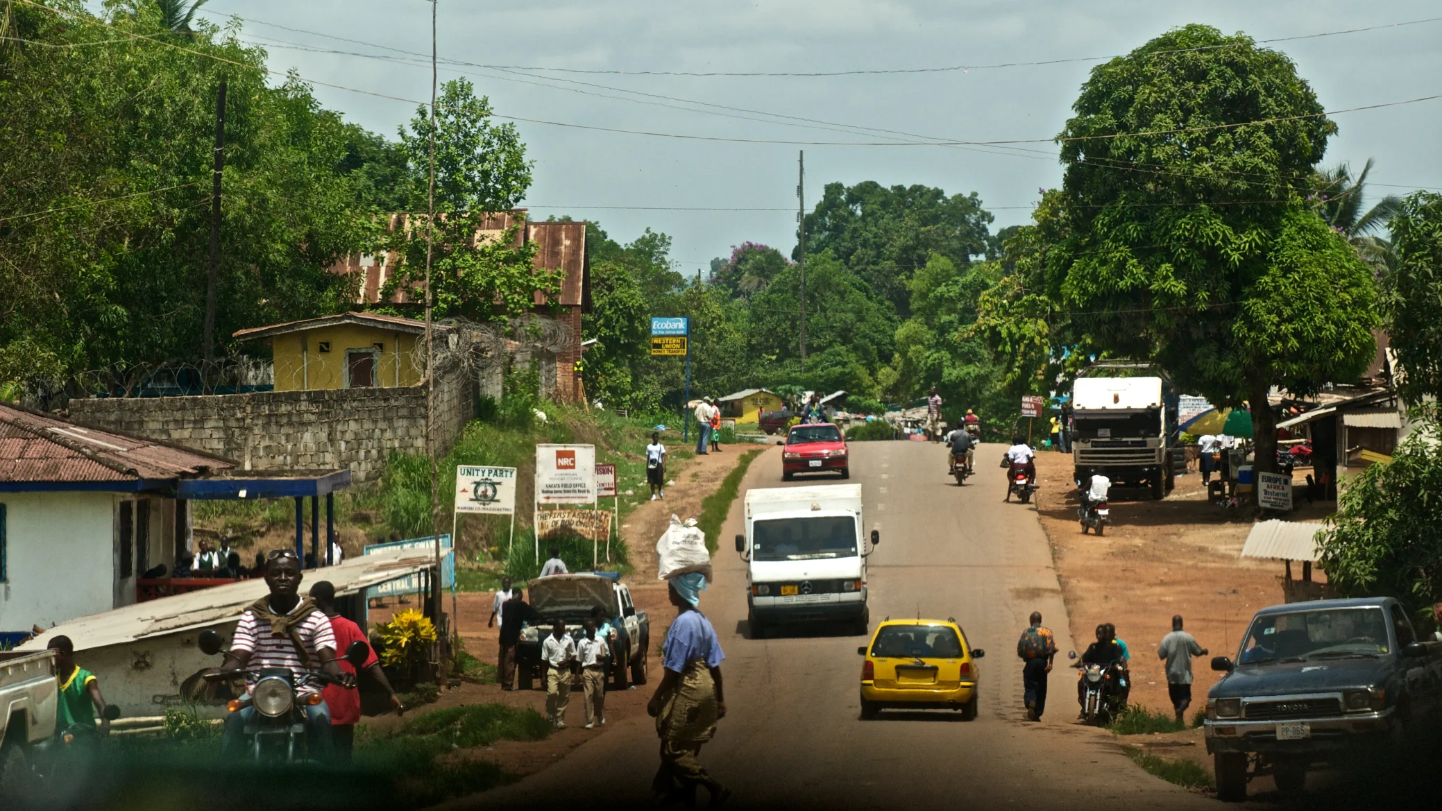 "City of Kakata, photograph of main road near BWI, May 2012" by Thadk - Living in Kakata. Licensed under CC BY-SA 3.0