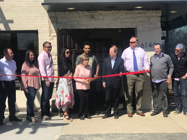 Solon Mayor Edward Kraus, center, with owner Bret Adams and his wife Michelle, third and forth left, and her family members along with city representatives at Rose Italian Kitchen's grand opening ribbon cutting ceremony. 
