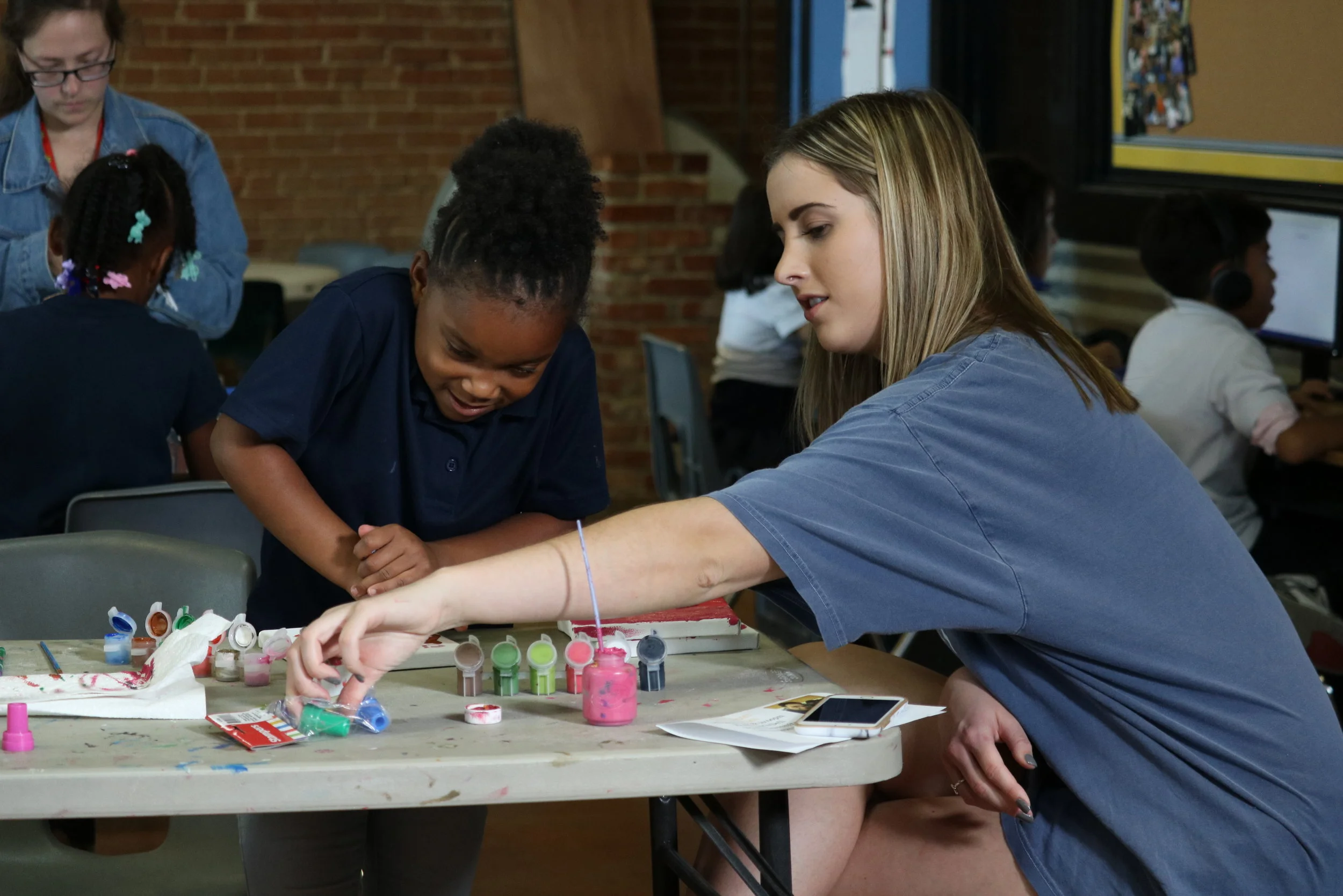 Willow and her mentor complete a craft project.