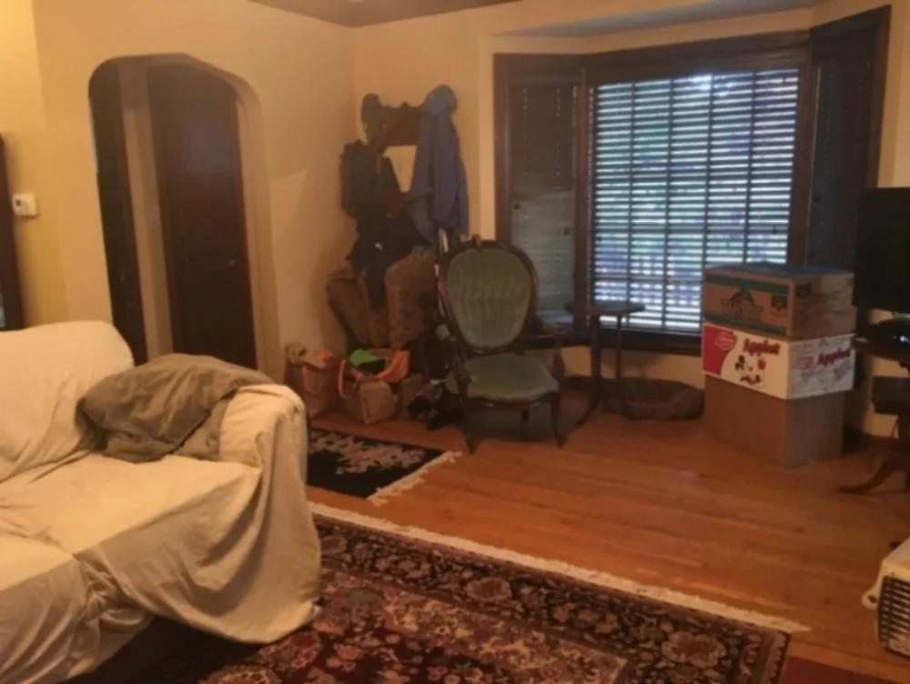 Before: As you can see here, there were far too many things on the floors and against the walls to get a sense of the space. It feels dark and cramped and you can't get a good sense of the space and how it can be used effectively.