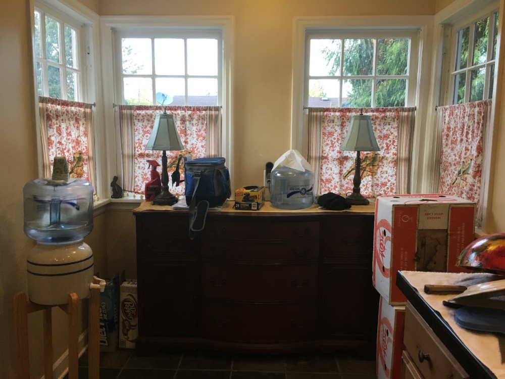 Before: In the kitchen nook area, the sellers have a large dresser and miscellaneous boxes and other items. It has become a sort of "catch-all" area. It makes the space feel cramped and dark.