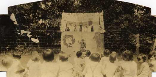 Children watch a puppet show at Guggenheimer-Milliken in 1930.
