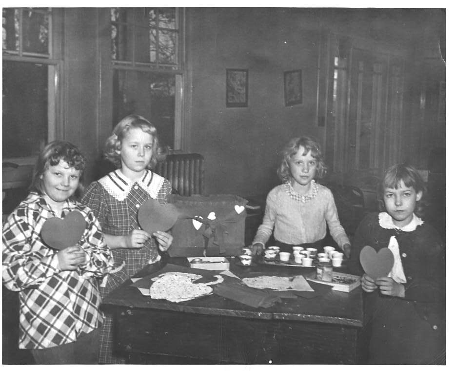 Four girls display their handmade Valentines, made at the Guggenheimer-Milliken community center in 1950.