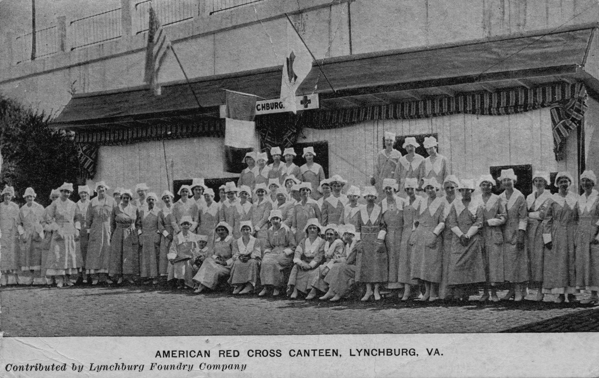 lucille McWane (the future mrs. e.A. Watson) is pictured in the front row at the red cross canteen at kemper street station ca 1918