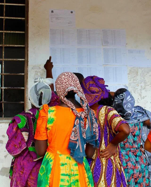 Women voters look for their names in the on the voter list in Kinondoni, Dar es Salaam.