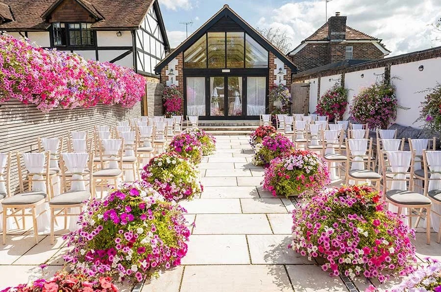 Wedding ceremony venue Random Hall decorated for the couple’s special day, ready for guests to take their seats at Slinfold.