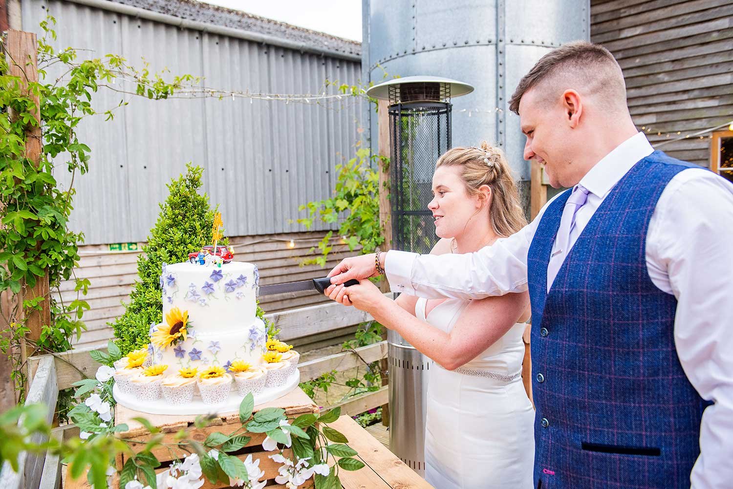 Sussex Bride and Groom cutting cake