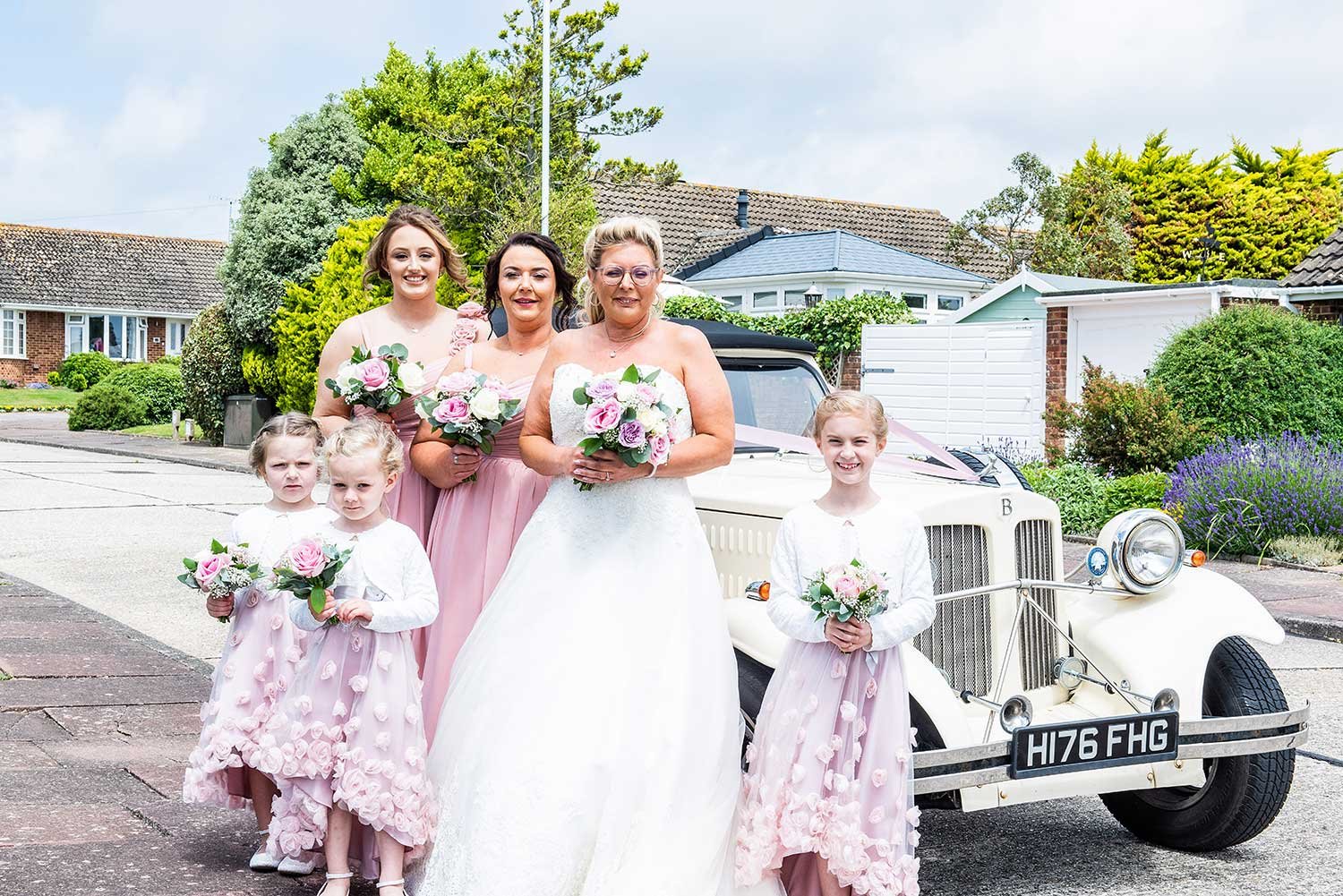 Sussex Bride and Bridesmaids outside Wedding Car