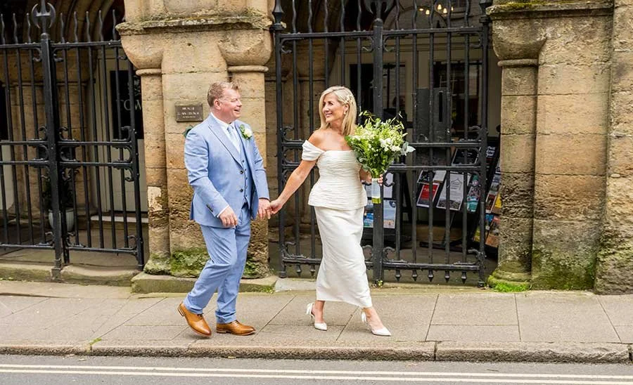 Bride and groom sharing a romantic couple portrait surrounded by historic Arundel architecture