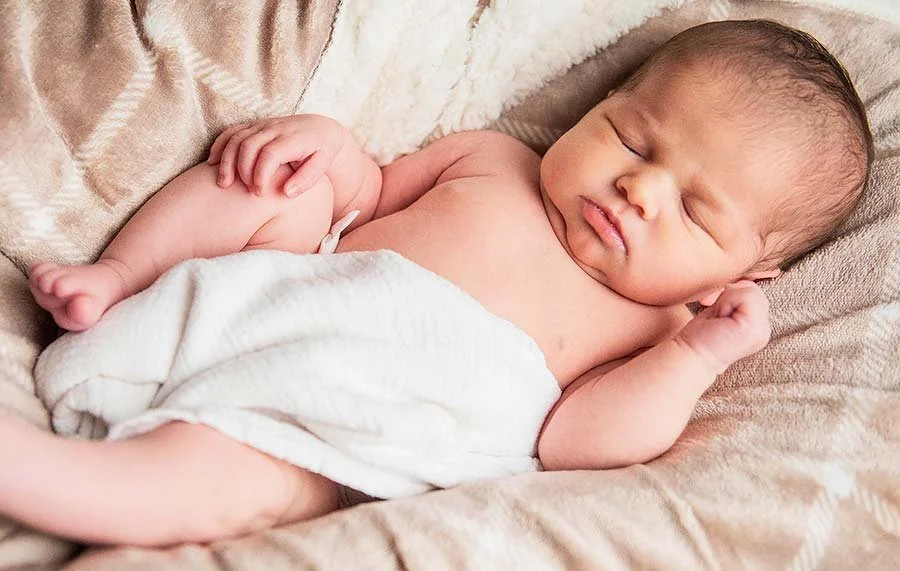 Close-up portrait of a newborn baby with delicate features photographed in a professional studio setting in Littlehampton