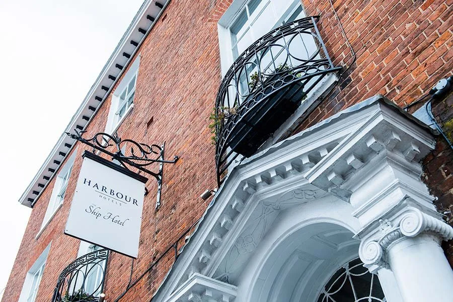 Another exterior of Chichester Harbour Hotel in Chichester, West Sussex, showing the modern building and landscaped grounds.