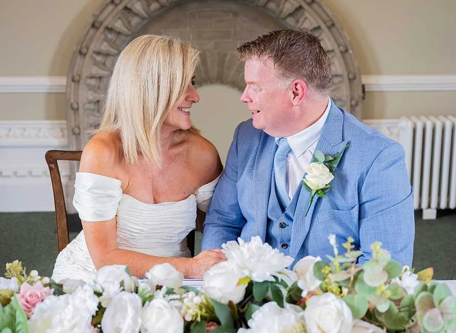 Bride and groom smiling together after signing their marriage certificate at Arundel Town Hall