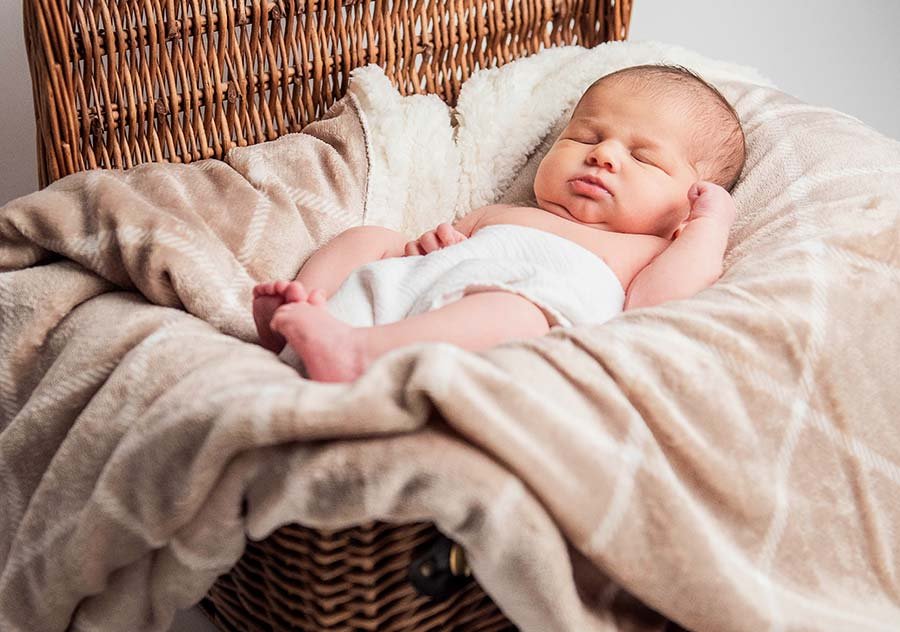 Timeless newborn photography capturing tiny details and gentle expressions in a Sussex newborn photoshoot