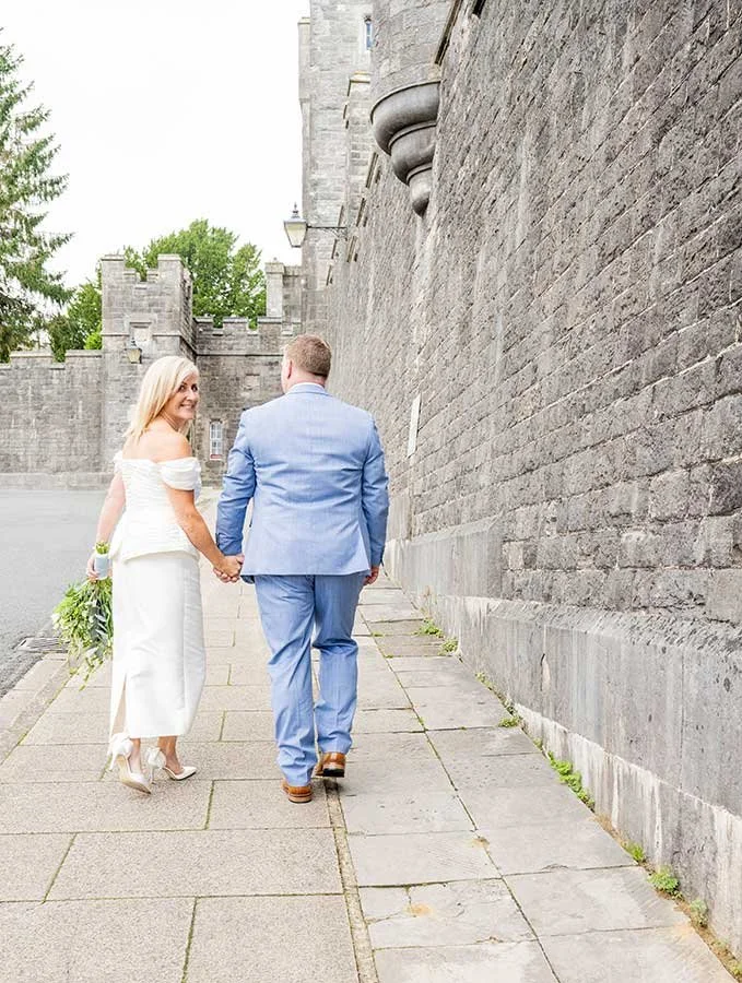 Bride and groom walking through Arundel after their town hall wedding ceremony