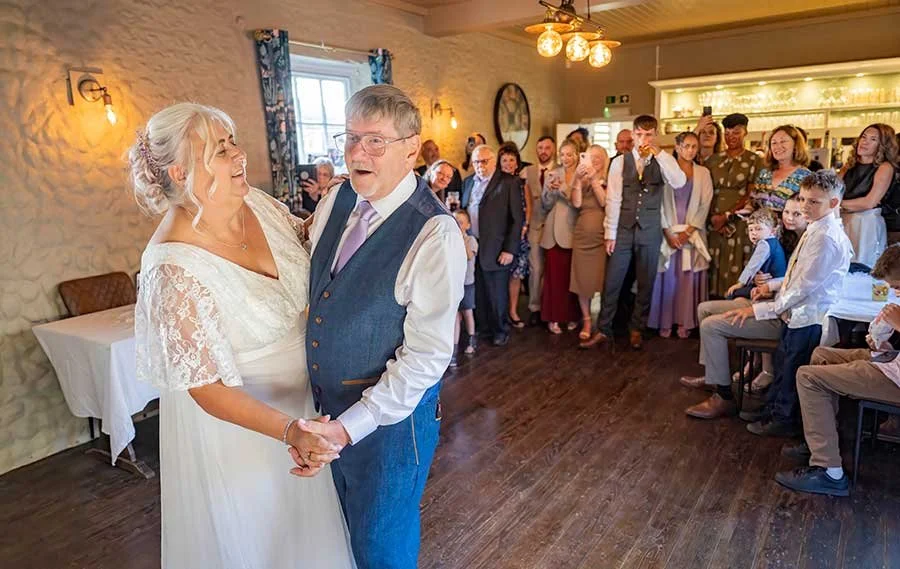 Bride and groom first dance at The Six Bells, Lyminster surrounding with guests.
