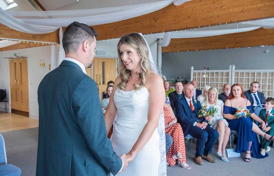 Wedding ceremony at Chichester Yacht Club with bride and groom exchanging vows