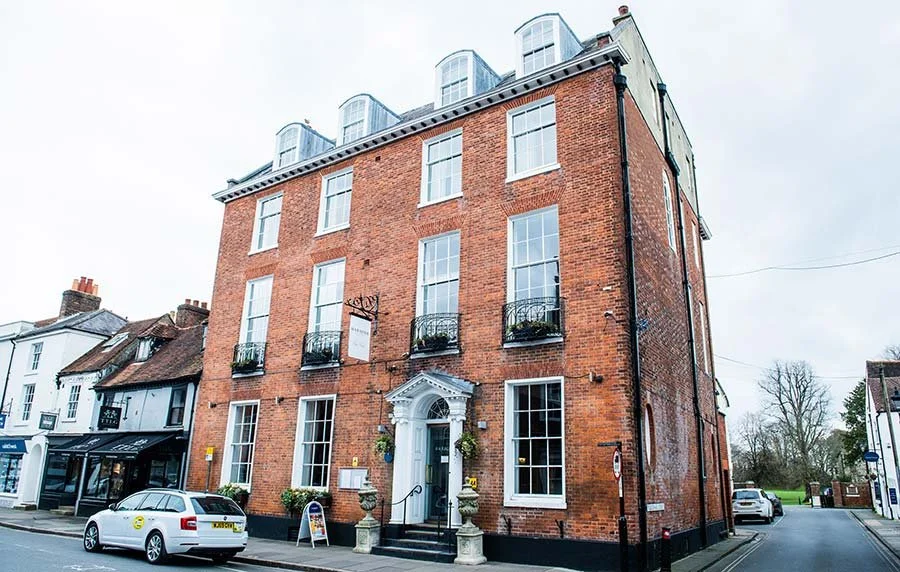 Exterior of Chichester Harbour Hotel in Chichester, West Sussex, showing the modern building and landscaped grounds.