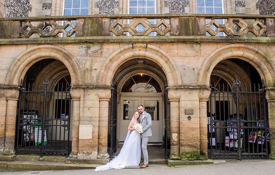 Bride and groom sharing a quiet, intimate moment together at Arundel Town Hall, with natural light highlighting their happiness.